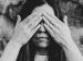 woman covering her eyes with her hands.