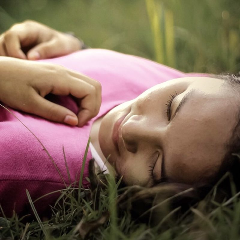 girl lying in the grass