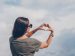 woman forming a heart with her hands.