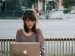 woman reading on her laptop.