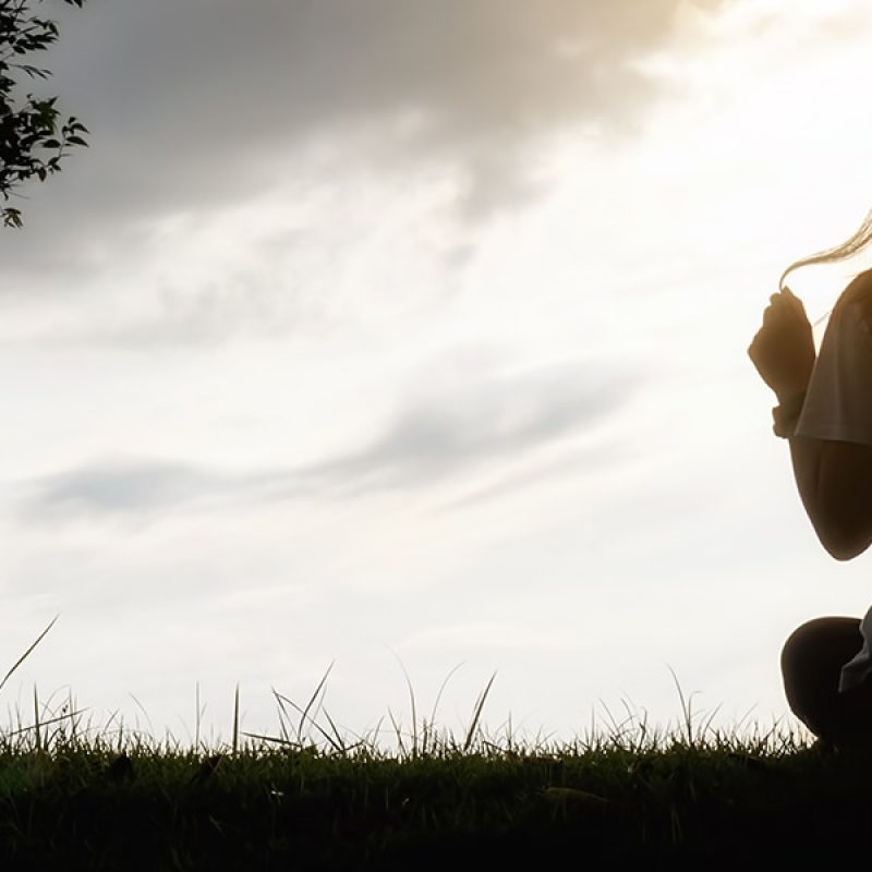 woman sitting in a field in serenity
