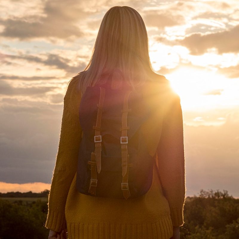 woman reflecting while watching a sunset
