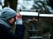 Woman looking beyond through telescope