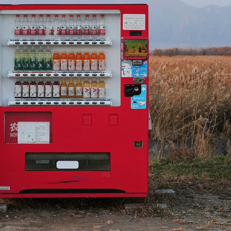 woman standing in front of a vending machine